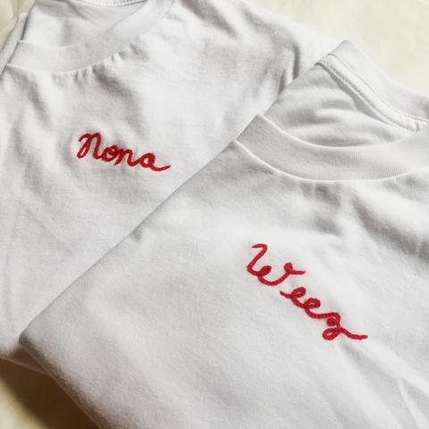 custom chainstitch embroidery on white tshirt with red cursive lettering