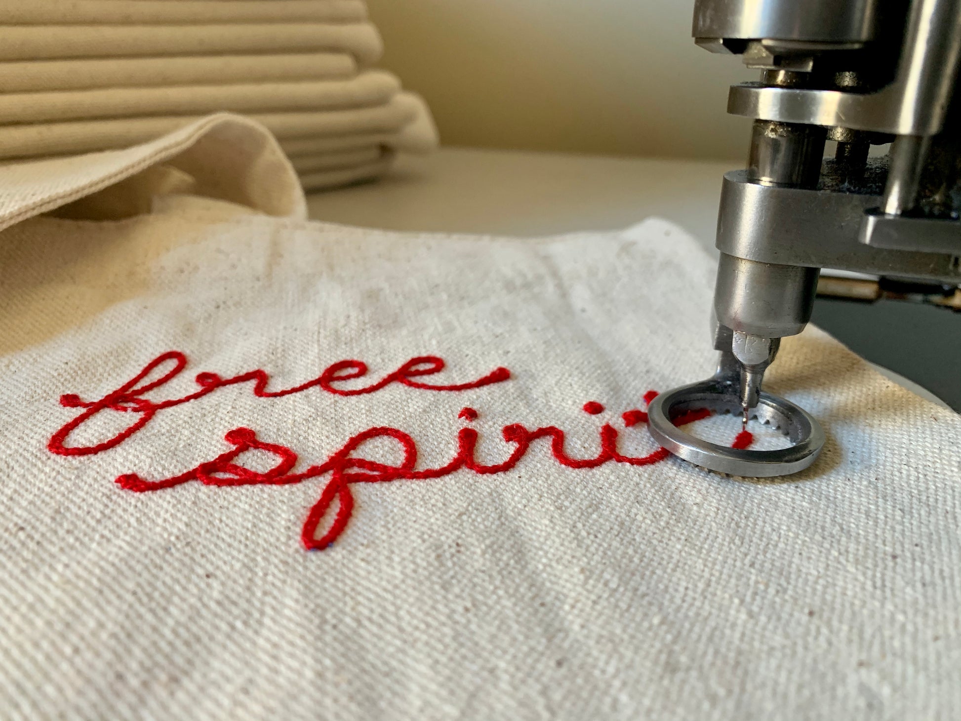 Canvas tote bag with free spirit in red lettering  embroidered with custom chain stitch embroidery with a chainstitch machine